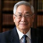 Headshot of Professor David Chen, a distinguished man with spectacles, in an academic or library setting.